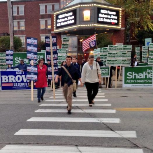UNH journalism student Tom Spencer leads his classmates through the crowd outside the Capitol Center for the Arts in Concord, NH on Oct. 21, 2014. Photo/Meg Heckman 